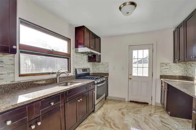 a kitchen with a sink stove and cabinets