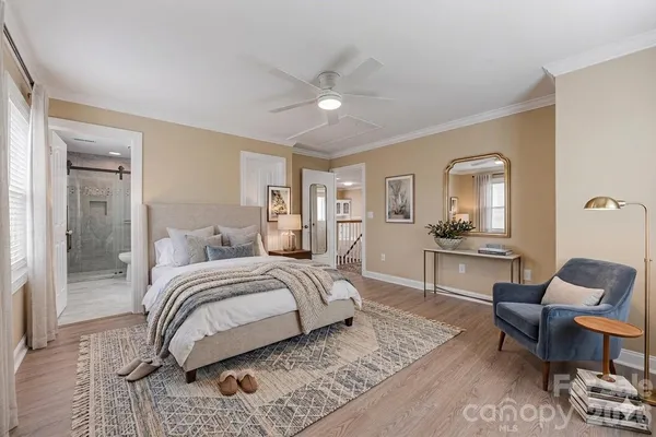 a bedroom with a bed a couch and dresser