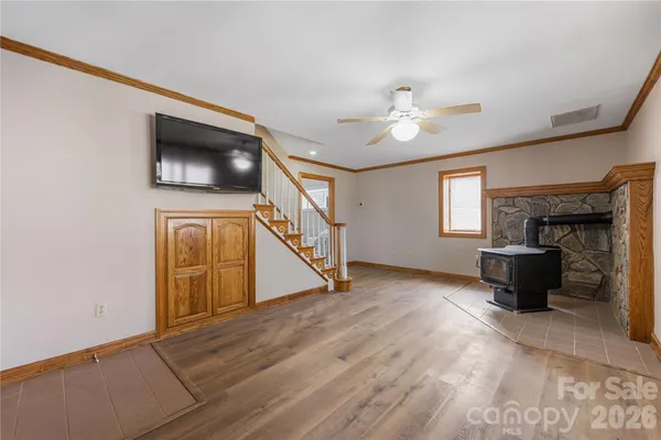 a view of empty room with fireplace and fan