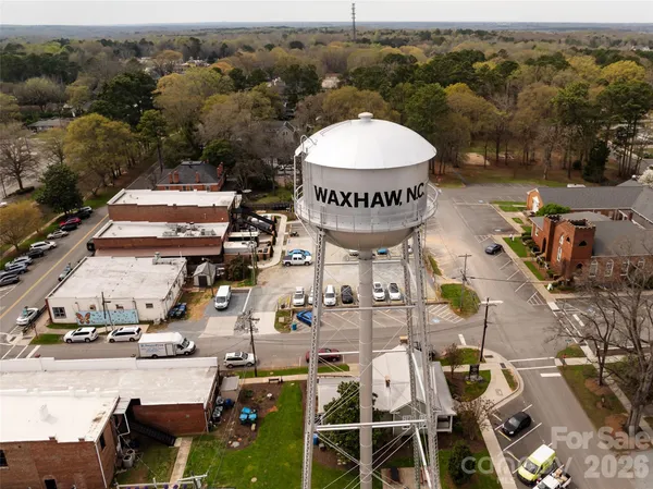 an aerial view of a house with a garden and trees
