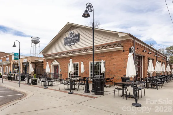 a front view of a building with outdoor seating