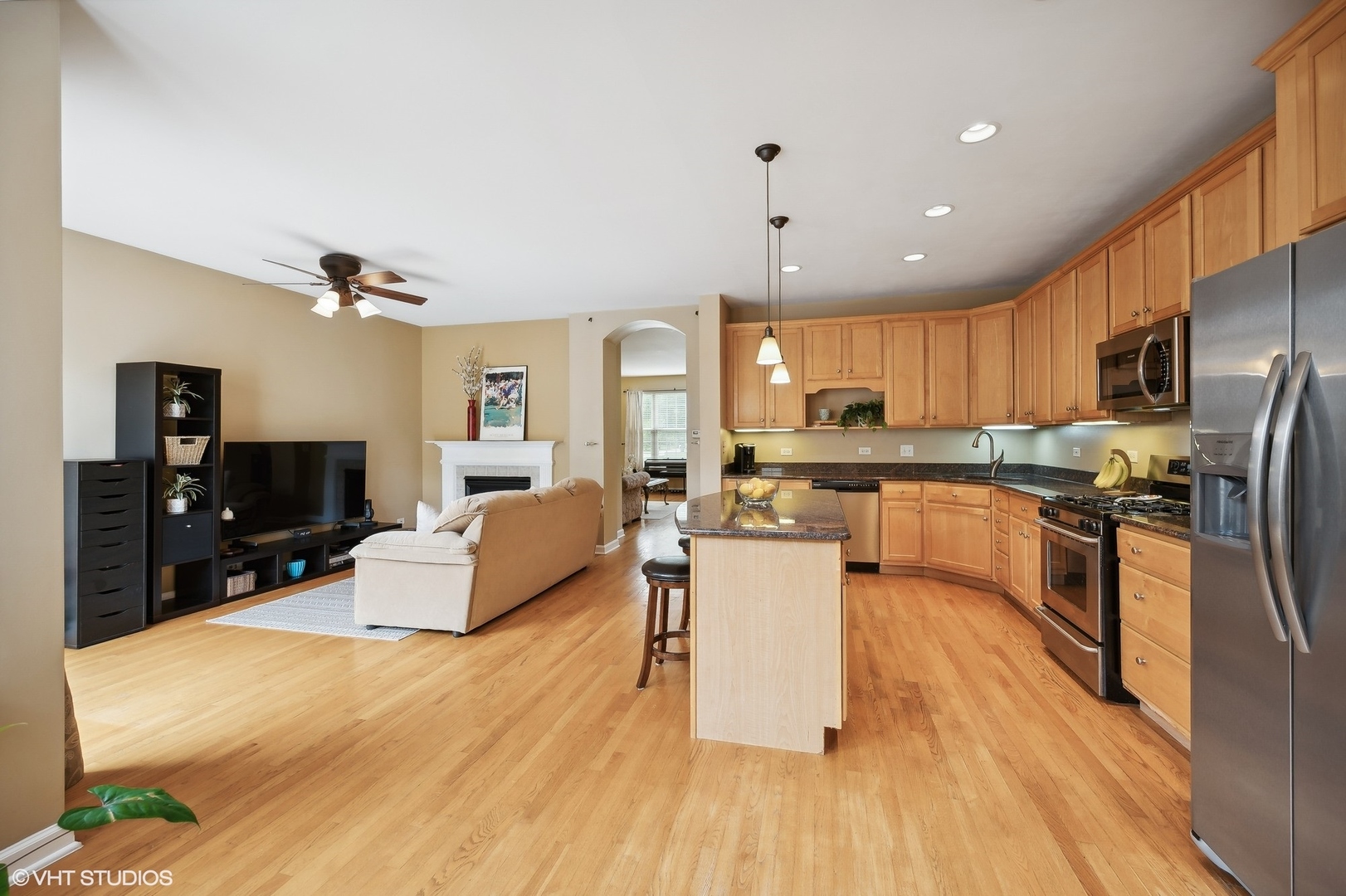 2703 Langley Circle Glenview, IL 60026 - Photo 6 of 23 a kitchen with stainless steel appliances kitchen island granite countertop a refrigerator a stove top oven a sink dishwasher and white cabinets with wooden floor