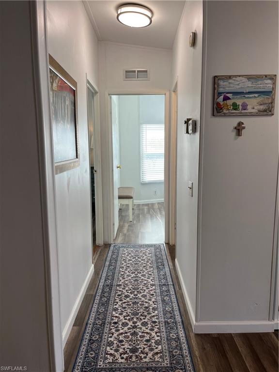 53 Oceans Boulevard, Unit 53 Naples, FL 34104 - Photo 13 of 42 a view of a hallway with wooden floor and a bathroom