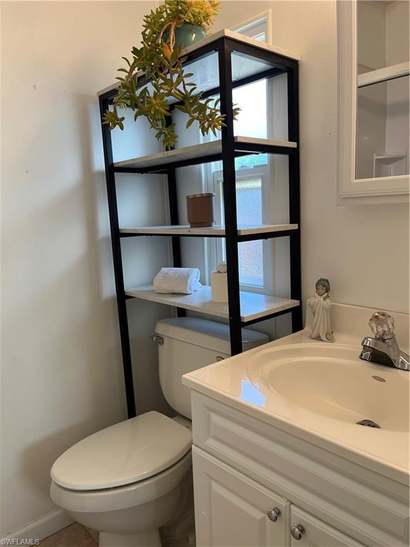 53 Oceans Boulevard, Unit 53 Naples, FL 34104 - Photo 18 of 42 a bathroom with a toilet sink and mirror