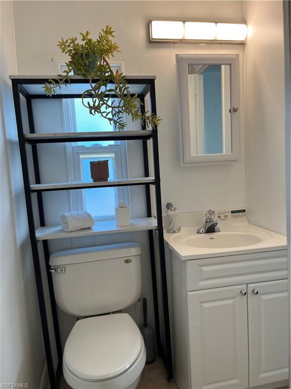 53 Oceans Boulevard, Unit 53 Naples, FL 34104 - Photo 19 of 42 a bathroom with a sink a toilet and mirror