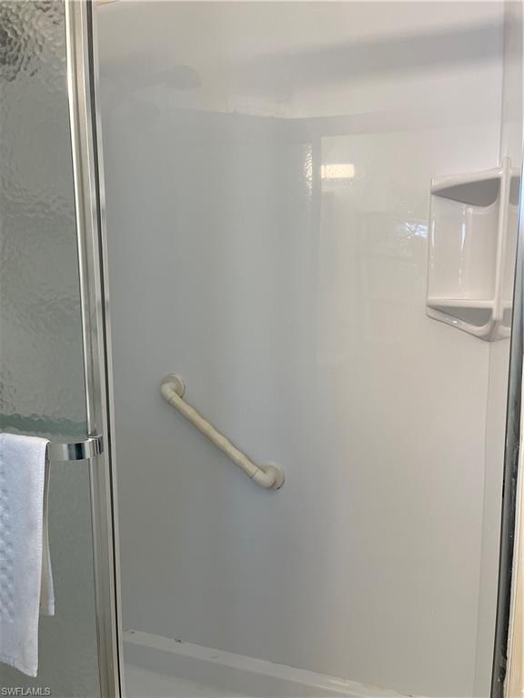 53 Oceans Boulevard, Unit 53 Naples, FL 34104 - Photo 20 of 42 a bathroom with a shower