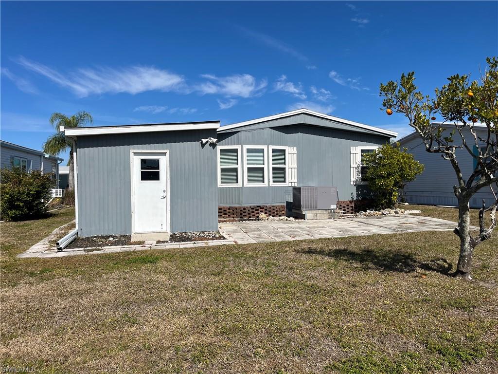 53 Oceans Boulevard, Unit 53 Naples, FL 34104 - Photo 2 of 42 a front view of a house with a yard
