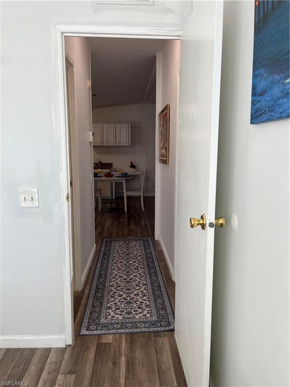 53 Oceans Boulevard, Unit 53 Naples, FL 34104 - Photo 24 of 42 a view of a hallway with wooden floor and a living room
