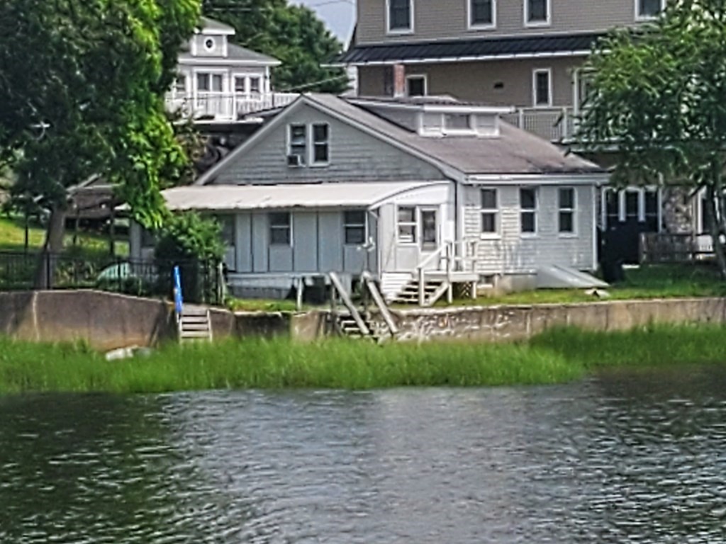 a front view of a house with a yard table and chairs