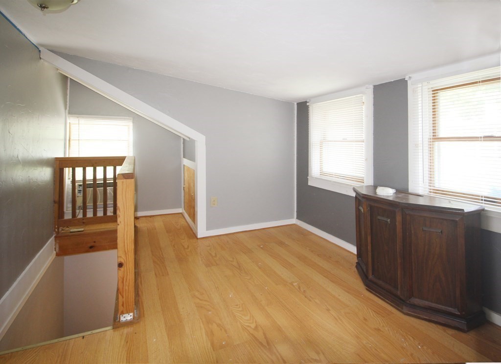 12 B Barnacle Road Wareham, MA 02571 - Photo 13 of 14 a view of an empty room with wooden floor and a window