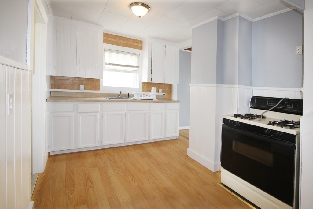 12 B Barnacle Road Wareham, MA 02571 - Photo 8 of 14 a kitchen with granite countertop a stove and a sink