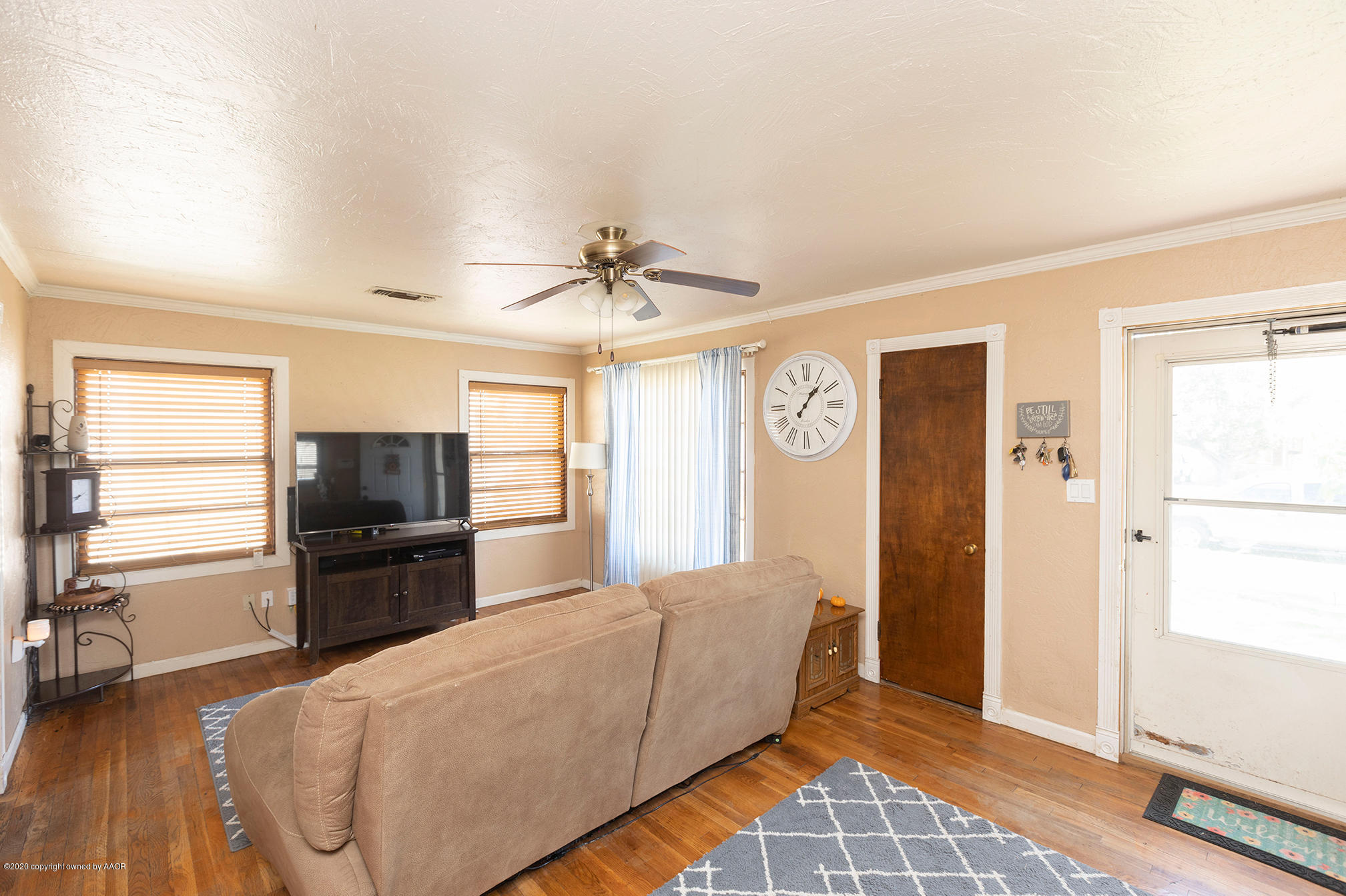 4222 Gables Street Amarillo, TX 79110 - Photo 3 of 18 a living room with stainless steel appliances furniture and a flat screen tv