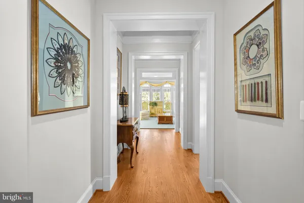 a kitchen with stainless steel appliances granite countertop a stove top oven a sink dishwasher a dining table and chairs with wooden floor
