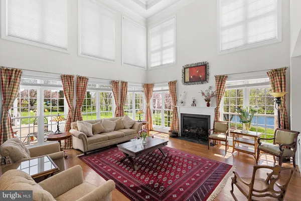 a living room with furniture a table and a large window