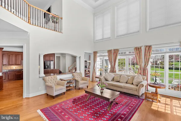a living room with furniture fireplace and a large window