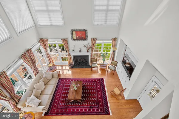 a kitchen with stainless steel appliances granite countertop a stove top oven a sink dishwasher a refrigerator and cabinets with wooden floor
