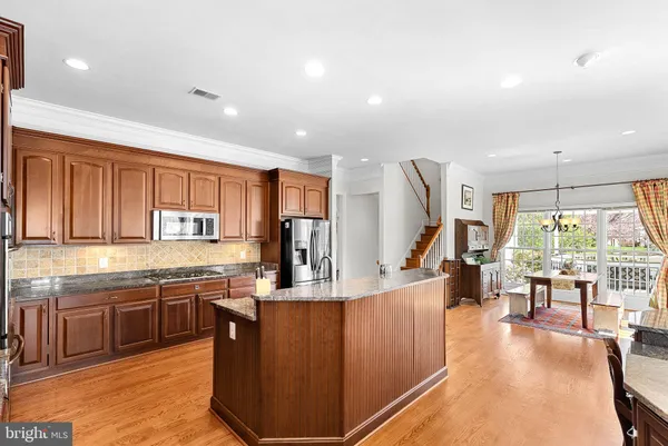 a view of a a dining room with furniture window and wooden floor