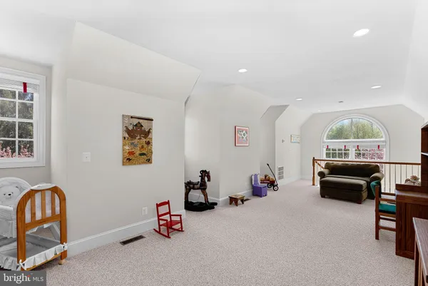 a bedroom with a bed chair and a window