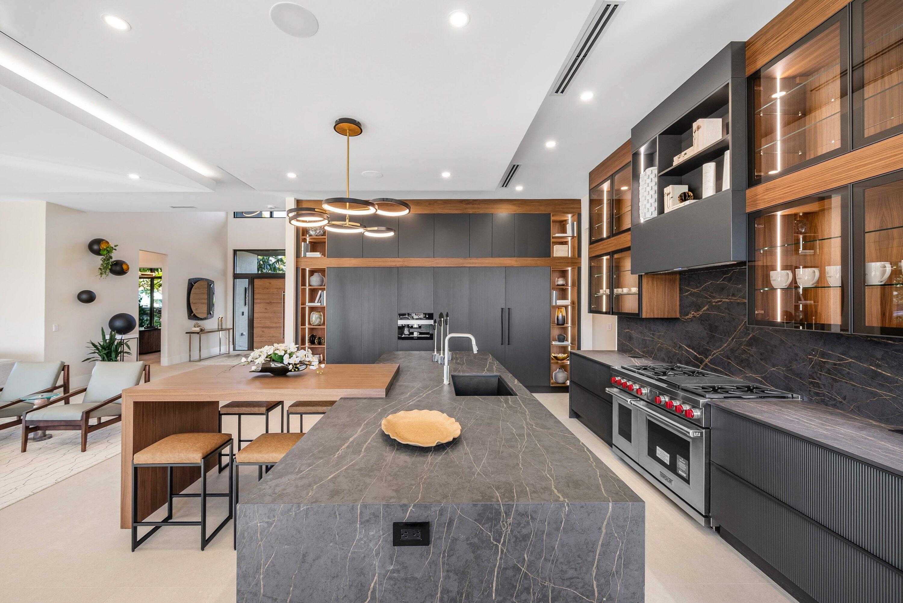 728 Enfield Street Boca Raton, FL 33487 - Photo 11 of 50 a kitchen with stainless steel appliances granite countertop a stove and a dining table