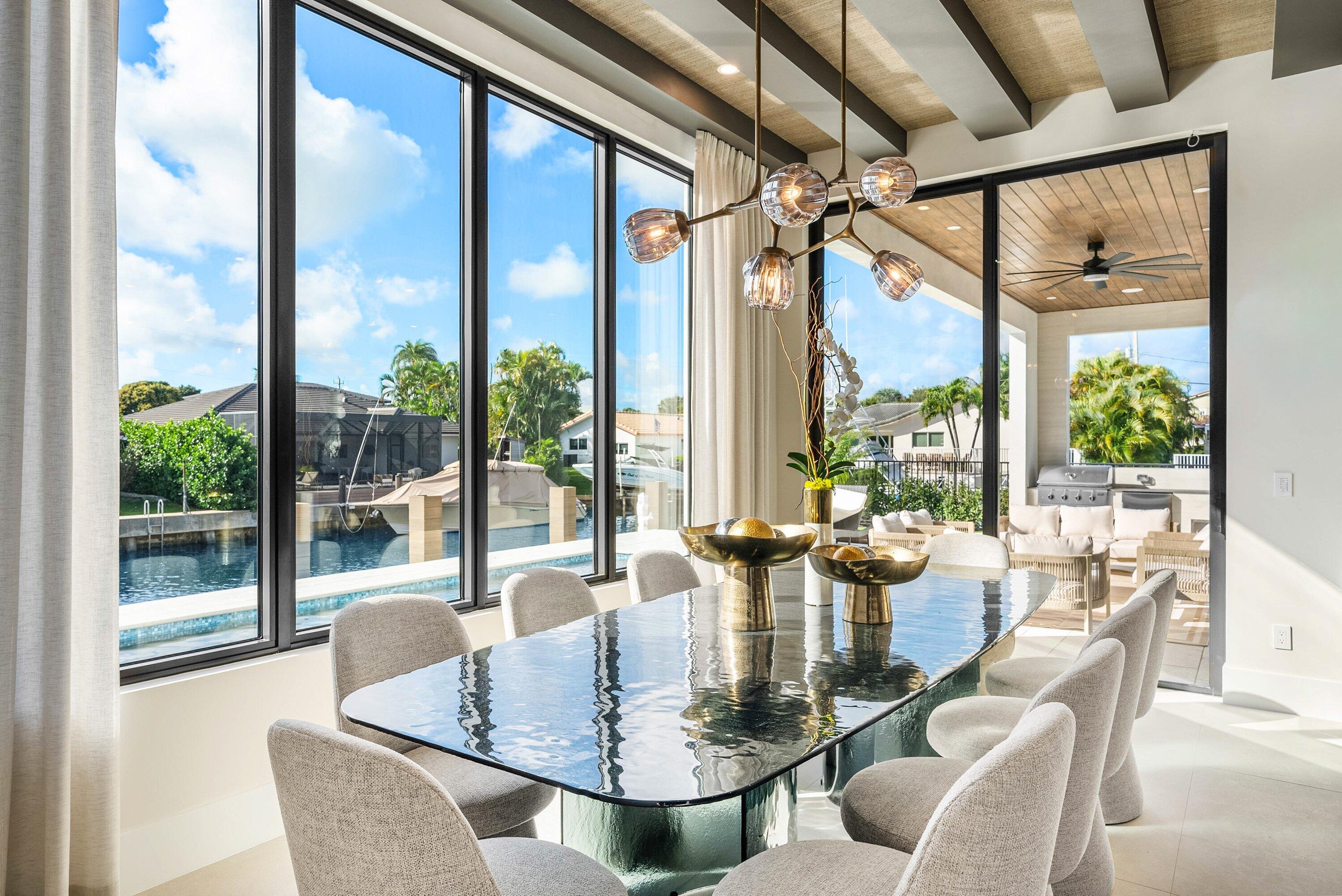 728 Enfield Street Boca Raton, FL 33487 - Photo 12 of 50 a dining room with furniture a chandelier and wooden floor