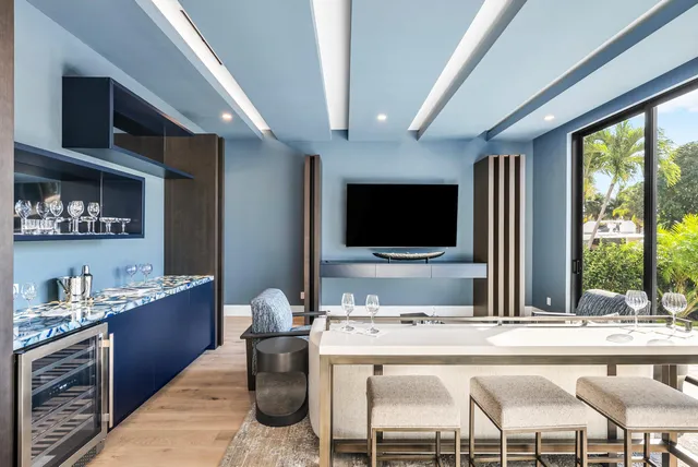 a living room with a flat screen tv and a large window