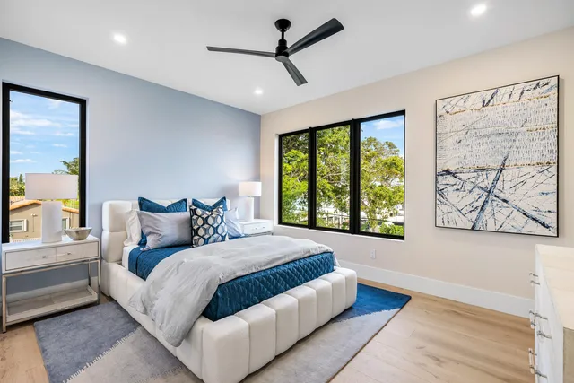 a bedroom with a large bed and a chandelier