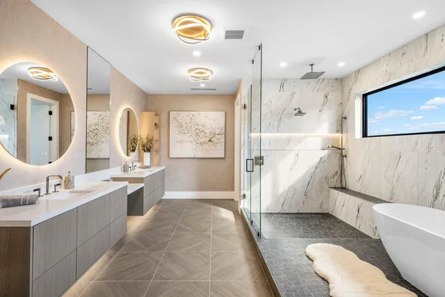 a bathroom with a tub a sink and mirror
