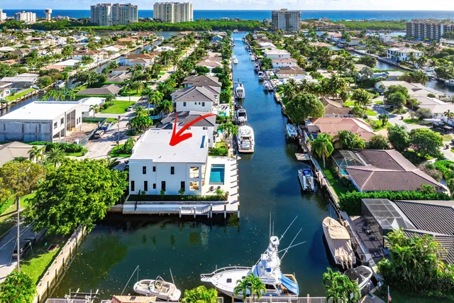 an aerial view of residential houses with outdoor space and swimming pool