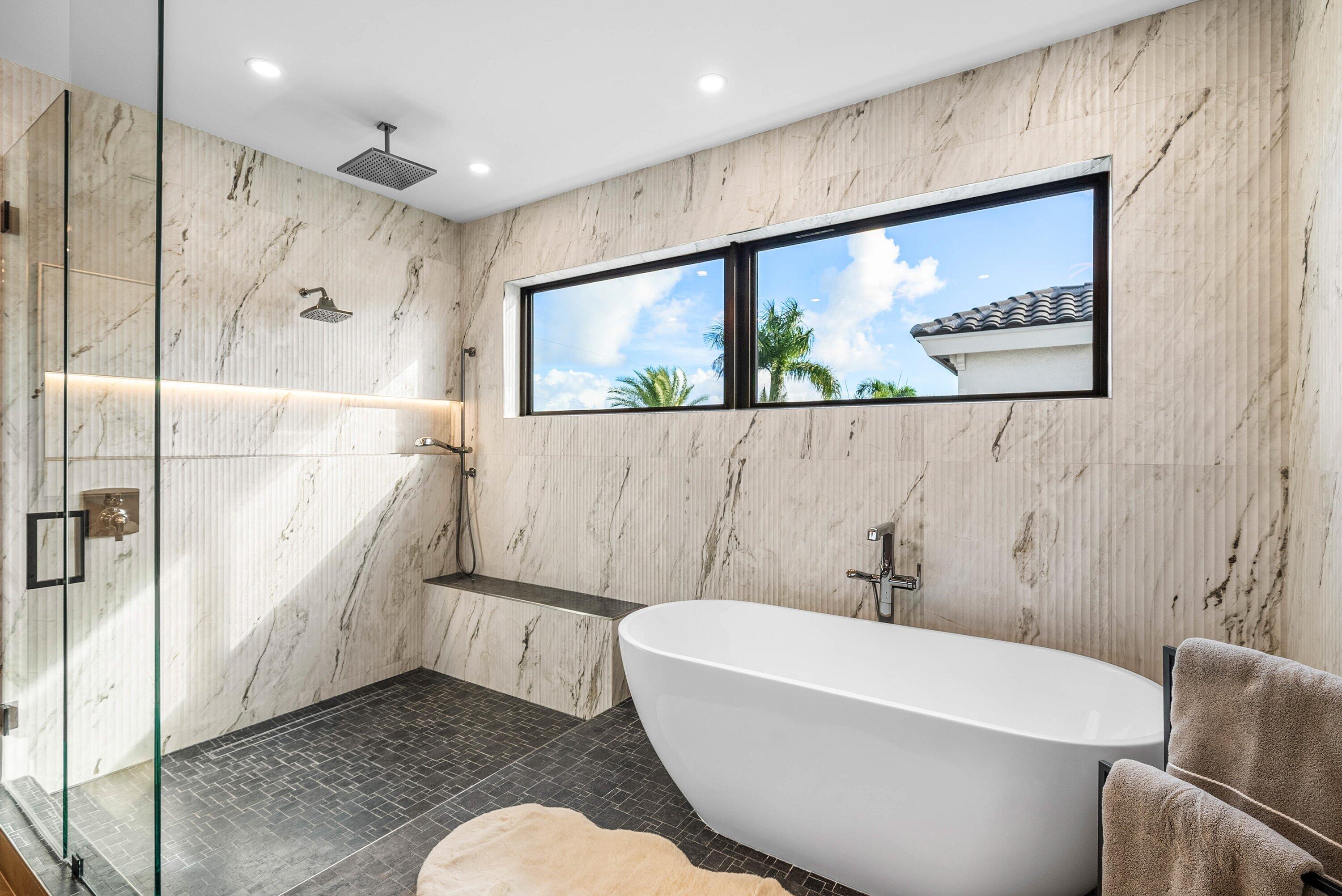 728 Enfield Street Boca Raton, FL 33487 - Photo 31 of 50 a bathroom with a bathtub and a shower