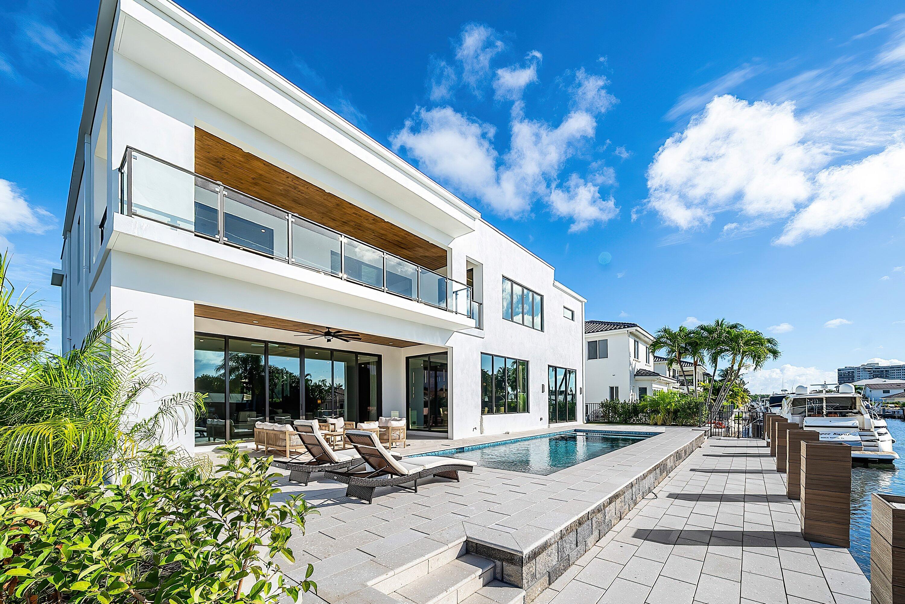 728 Enfield Street Boca Raton, FL 33487 - Photo 43 of 50 a view of a patio with couches table and chairs and potted plants