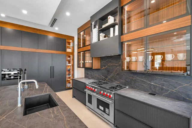 a open kitchen with stainless steel appliances granite countertop a stove and a sink