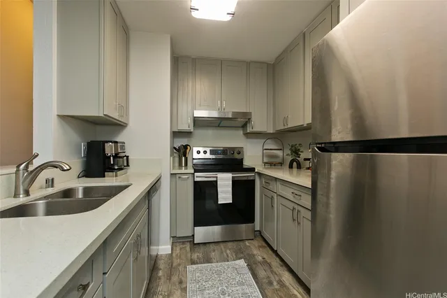 a kitchen with a sink cabinets and stainless steel appliances