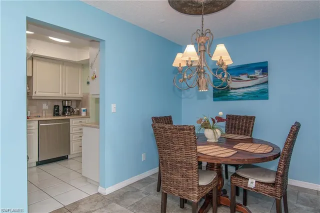 a view of a dining room with furniture wooden floor and chandelier