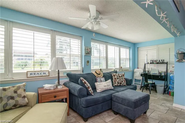 a living room with furniture and large windows