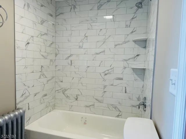 a bathroom with a bathtub and a toilet