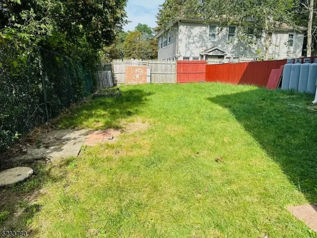 a view of backyard with swimming pool