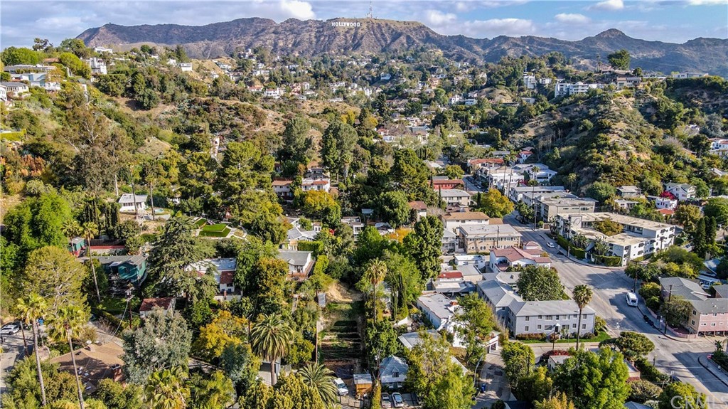 an aerial view of residential house with an outdoor space and seating