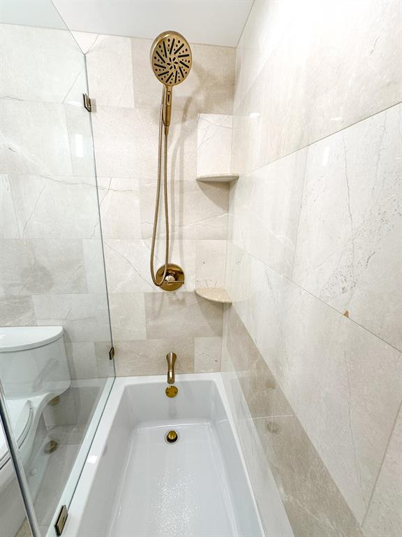 4800 Bayview Drive, Unit 503 Fort Lauderdale, FL 33308 - Photo 21 of 30 a bathroom with a tub a sink and a shower