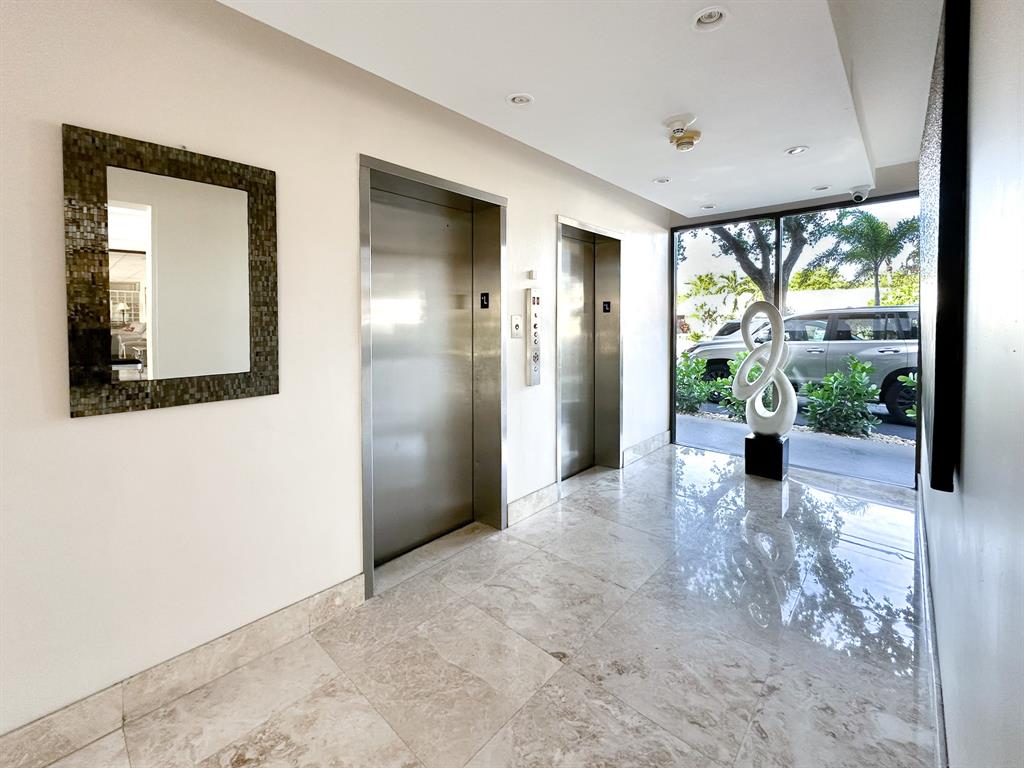 4800 Bayview Drive, Unit 503 Fort Lauderdale, FL 33308 - Photo 26 of 30 a view of a hallway with wooden floor and a living room