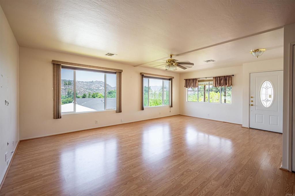 4650 Dulin Road, Unit 119 Fallbrook, CA 92003 - Photo 19 of 49 a view of an empty room with wooden floor and a window