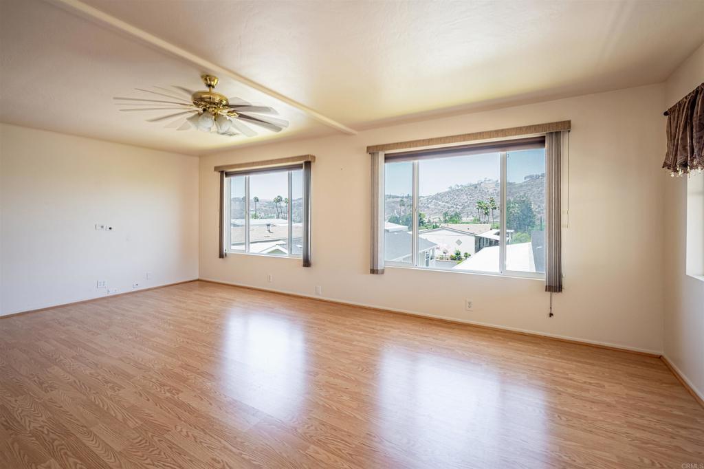 4650 Dulin Road, Unit 119 Fallbrook, CA 92003 - Photo 20 of 49 a view of an empty room with wooden floor and window