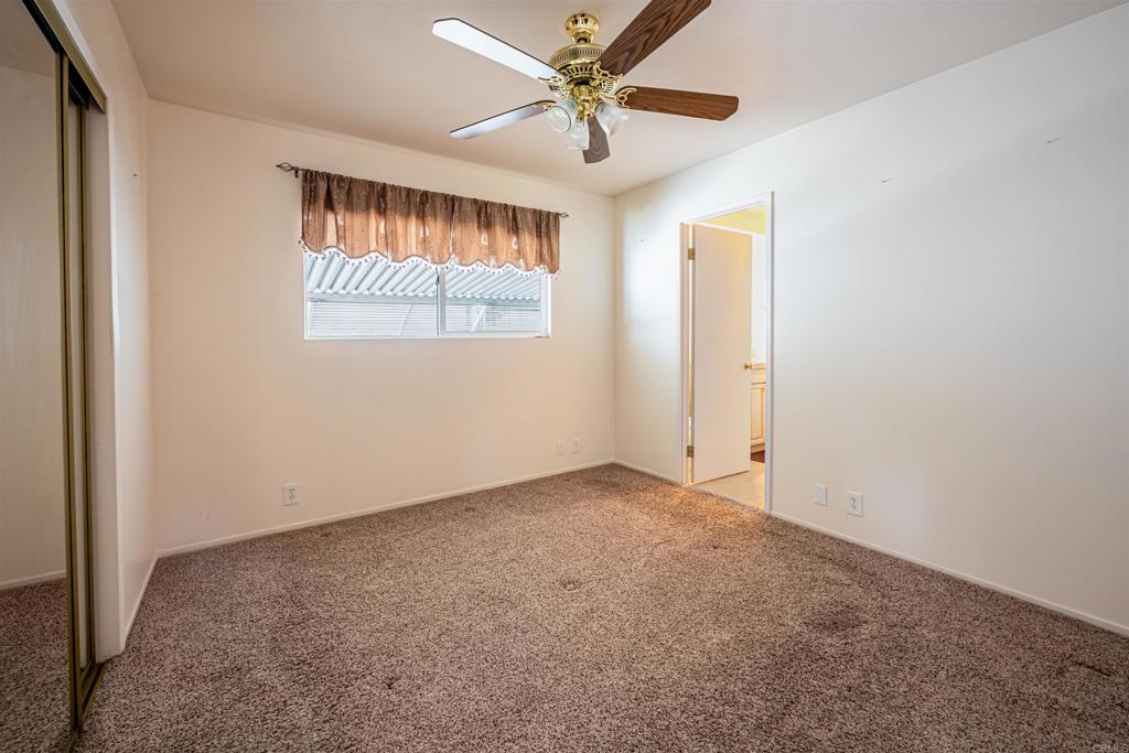 4650 Dulin Road, Unit 119 Fallbrook, CA 92003 - Photo 27 of 49 an empty room with windows and fan