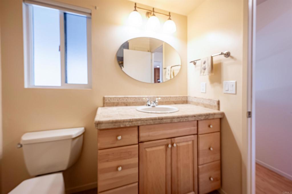 4650 Dulin Road, Unit 119 Fallbrook, CA 92003 - Photo 28 of 49 a bathroom with a toilet a sink and mirror