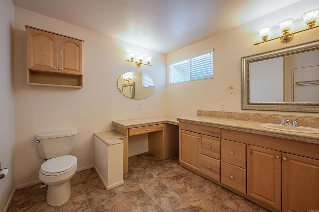 4650 Dulin Road, Unit 119 Fallbrook, CA 92003 - Photo 33 of 49 a spacious bathroom with a toilet sink and mirror