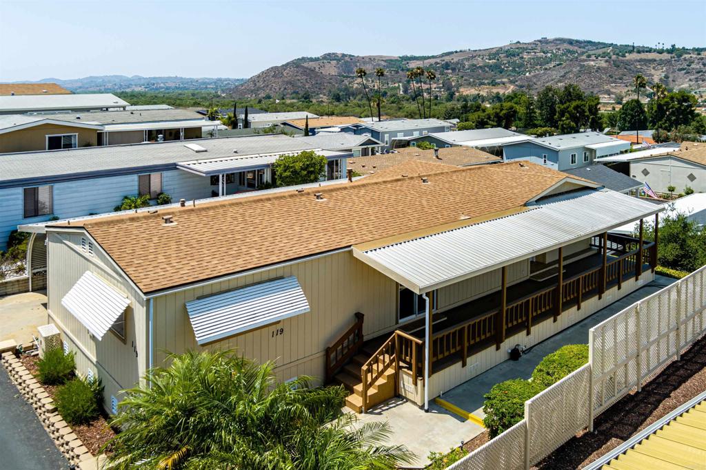 4650 Dulin Road, Unit 119 Fallbrook, CA 92003 - Photo 5 of 49 an aerial view of residential houses with yard and mountain view in back