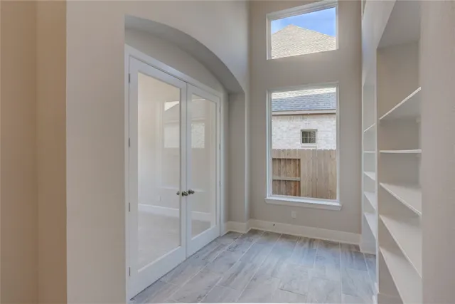 an empty room with wooden floor and a window