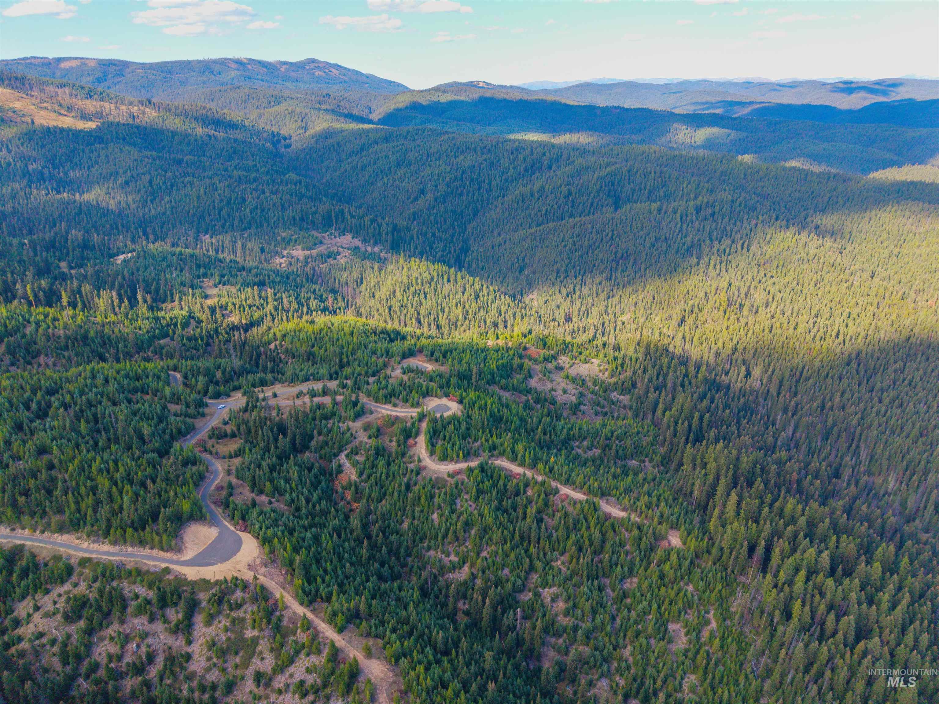8 Tree Farm Trails Road Elk City, ID 83525 - Photo 10 of 14 Aerial view of property's location featuring a mountain backdrop and a heavily wooded area