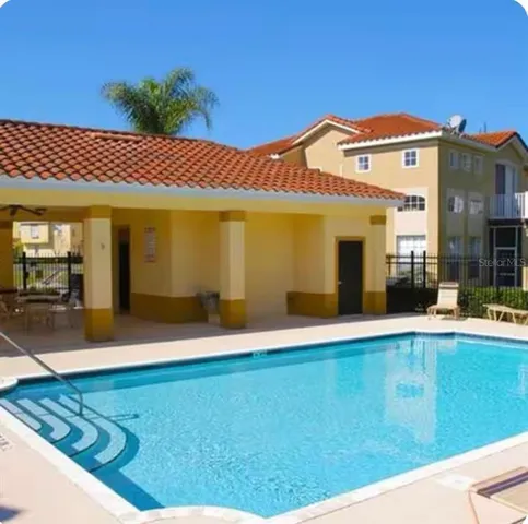 a view of an house with backyard space and balcony