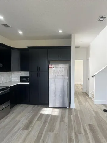 a kitchen with a refrigerator and a sink
