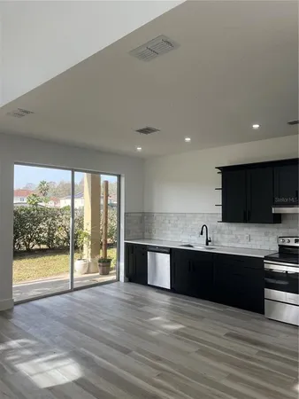 a view of kitchen with wooden floor and sink